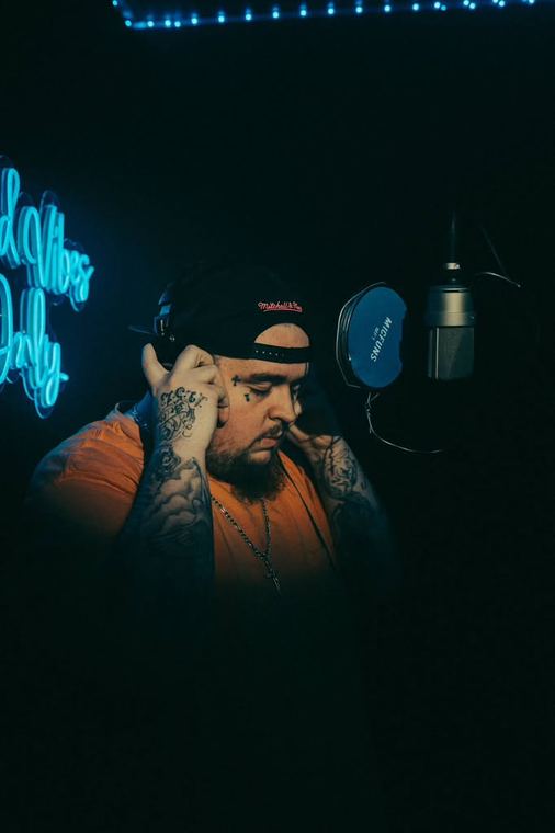 Head down in the booth, neon behind
